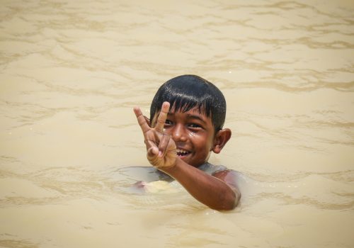 Boy swimming in the pond