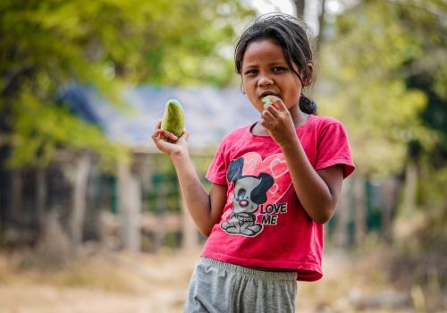 Girl eating mango