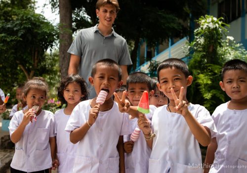 Group photo of participant with students