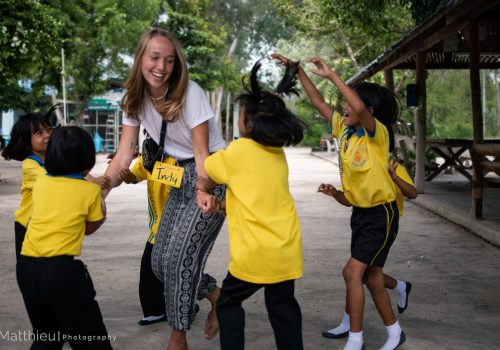 Participant playing with students during break time