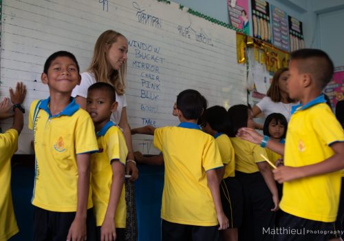 Participant with students writing on the board