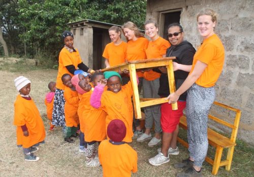 _Participants and students carrying a new desk