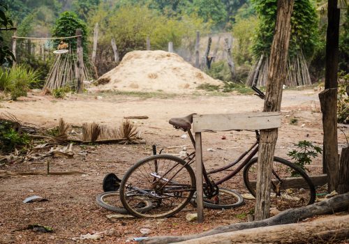 Rusty bicycle on road side