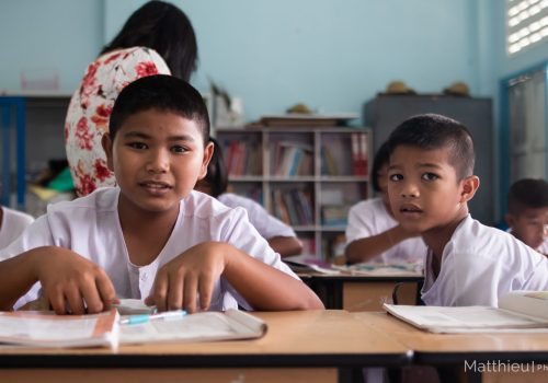 Students sit on their desk