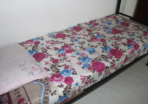 bed with floral bedcovers(1)