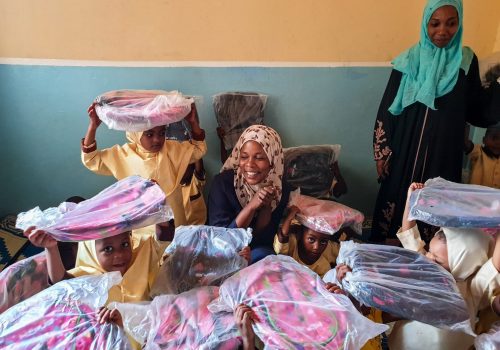 _giving school supplies to students